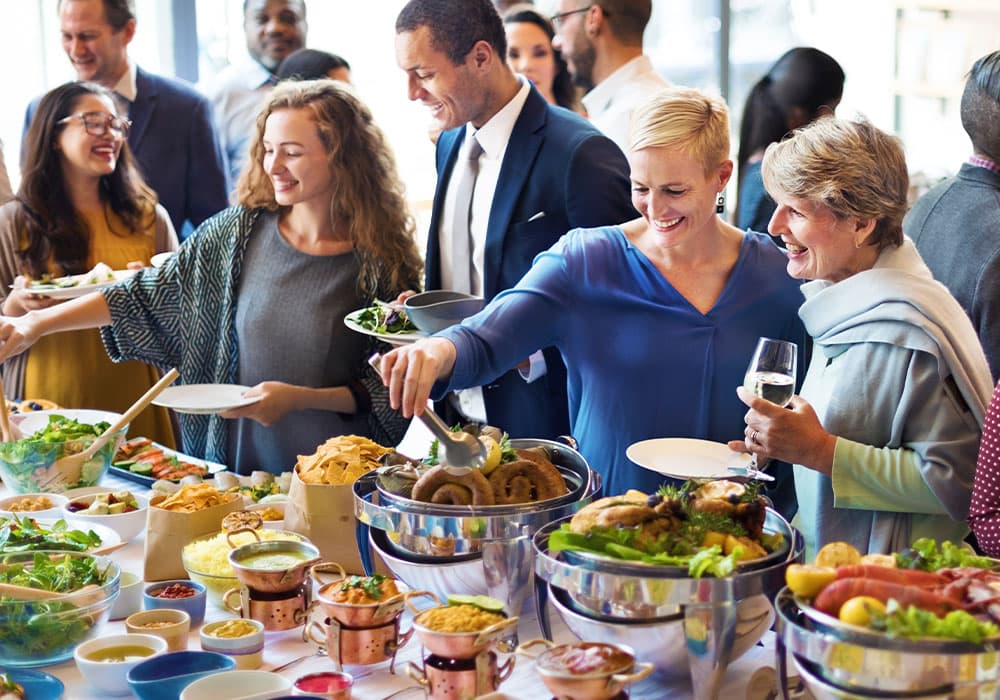 https://bloggers0775eb10c0.wordpress.com/wp-content/uploads/2025/09/people-smiling-at-a-catered-event-with-wine-and-food.jpg